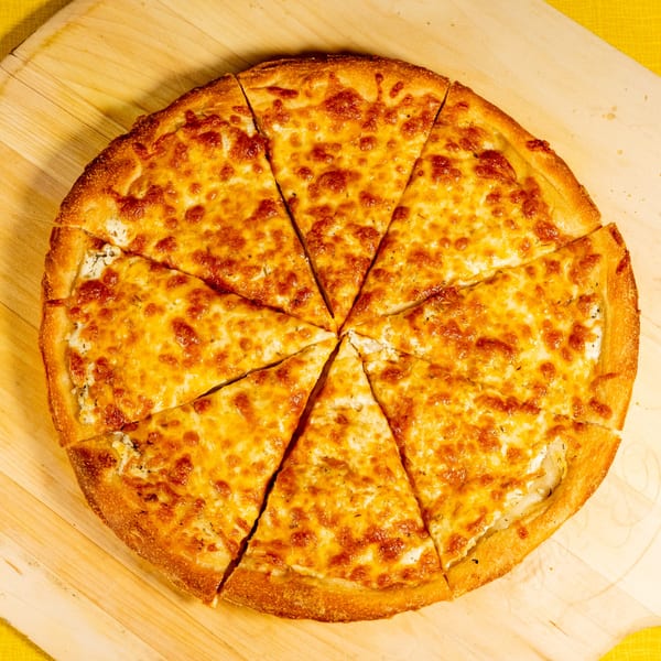 A freshly baked, golden-brown cheese pizza, sliced into eight pieces, on a wooden board.